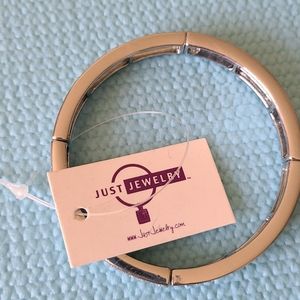 Silver color bracelet with rhinestones.